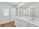 Modern bathroom boasts double sinks, white countertops, and a large mirror, and a glass-enclosed shower at 919 Montague Ave, Durham, NC 27703