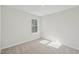Bedroom with window, carpet, and base trim at 919 Montague Ave, Durham, NC 27703