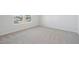 Bright bedroom features soft carpeting, neutral walls, and natural light from the double window at 919 Montague Ave, Durham, NC 27703