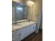 Elegant bathroom boasting a double vanity with granite countertop, modern fixtures, and a pristine tiled shower at 9254 Turkey Way, Middlesex, NC 27557