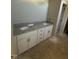 Bathroom vanity with dual sinks, granite countertop, and ample storage in white cabinets at 9254 Turkey Way, Middlesex, NC 27557