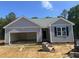 Charming single-story home with attached garage, vertical siding and blue skies above at 9254 Turkey Way, Middlesex, NC 27557