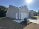 Exterior of a house with gray siding, a white garage door, and a well-maintained lawn under a sunny blue sky at 9254 Turkey Way, Middlesex, NC 27557
