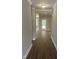 Inviting hallway featuring sleek hardwood floors and neutral-toned walls, leading to rooms bathed in natural light at 9254 Turkey Way, Middlesex, NC 27557