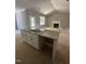 Kitchen with large island, stone countertops, stainless steel sink, and an adjacent living area at 9254 Turkey Way, Middlesex, NC 27557