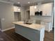 Stylish kitchen with granite countertops, white cabinets, stainless steel microwave, and a kitchen island at 9254 Turkey Way, Middlesex, NC 27557