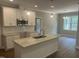 Modern kitchen with white cabinets, granite countertops, stainless steel appliances, and stylish pendant lighting at 9254 Turkey Way, Middlesex, NC 27557