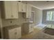 Kitchen with white cabinets, stone countertops, and stainless steel fixtures at 9254 Turkey Way, Middlesex, NC 27557