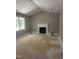 Spacious living room with a cozy fireplace, large windows, and neutral paint colors at 9254 Turkey Way, Middlesex, NC 27557