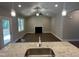 Open-concept living room featuring a fireplace, ceiling fan, and seamless flow from the kitchen island at 9254 Turkey Way, Middlesex, NC 27557