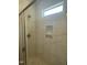 Luxurious shower features glass doors, stylish tile, a convenient niche, and a window that offers natural light at 9254 Turkey Way, Middlesex, NC 27557
