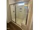 Modern shower with a glass door, tiled walls, a built-in bench, and a shower niche for storage at 9254 Turkey Way, Middlesex, NC 27557