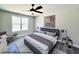 Staged bedroom with a large bed, soft lighting, and neutral color palette for a relaxing ambiance at 93 Butterbean Ct, Zebulon, NC 27597