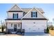 Charming two-story home with a two-car garage, classic design, and tasteful gray and white color scheme at 93 Butterbean Ct, Zebulon, NC 27597