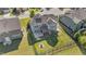 Aerial view of a fenced backyard with an outdoor kitchen, fire pit and a screened-in porch at 94 Pearsall Farm Ln, Clayton, NC 27527