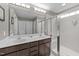 Bright bathroom with double sinks, a large mirror, walk-in shower, and modern finishes at 94 Pearsall Farm Ln, Clayton, NC 27527