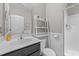 Well-lit bathroom with a single sink vanity, walk-in shower, and a ladder shelf for storage at 94 Pearsall Farm Ln, Clayton, NC 27527