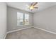 Cozy bedroom with neutral carpeting, abundant natural light, and a modern ceiling fan fixture at 94 Pearsall Farm Ln, Clayton, NC 27527