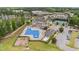Aerial view of the neighborhood clubhouse with pool, playground, tennis courts, and parking at 94 Pearsall Farm Ln, Clayton, NC 27527