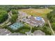 Aerial view features neighborhood tennis courts, soccer field, clubhouse, and pool at 94 Pearsall Farm Ln, Clayton, NC 27527