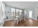 Inviting dining room features lots of natural light, elegant hardwood floors, and stylish modern furniture at 94 Pearsall Farm Ln, Clayton, NC 27527