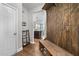 Inviting entryway featuring wood floors, custom hall tree, and seamless transition to the kitchen at 94 Pearsall Farm Ln, Clayton, NC 27527