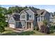 Beautiful two-story home with blue siding, stone accents, solar panels and a charming front patio at 94 Pearsall Farm Ln, Clayton, NC 27527