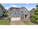 Charming home boasts solar panels, two-car garage, blue siding, and inviting front patio at 94 Pearsall Farm Ln, Clayton, NC 27527