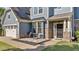 Inviting front porch with stone accents and cozy seating area at 94 Pearsall Farm Ln, Clayton, NC 27527