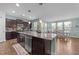 Well-equipped kitchen featuring granite counters, an island with seating, stainless appliances, and open dining area at 94 Pearsall Farm Ln, Clayton, NC 27527