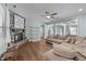 Comfortable living room with stone fireplace, ceiling fan, and seamlessly connects to other living areas at 94 Pearsall Farm Ln, Clayton, NC 27527