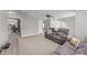 Open living room featuring plush carpeting, ceiling fan, and natural lighting at 94 Pearsall Farm Ln, Clayton, NC 27527