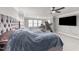 Lovely primary bedroom features a gray tufted headboard, ceiling fan, and dedicated workout space at 94 Pearsall Farm Ln, Clayton, NC 27527