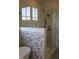 Bathroom with a large glass shower, floral tile accent wall, and a rainfall shower head at 976 Knob Hill Dr., Hillsborough, NC 27278
