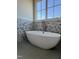 Modern free standing tub with brushed bronze faucet and floral accent wall at 976 Knob Hill Dr., Hillsborough, NC 27278