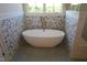 Modern free standing tub with brushed bronze faucet and floral accent wall at 976 Knob Hill Dr., Hillsborough, NC 27278