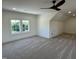 Bedroom with a large window, ceiling fan, base trim, gray carpet, and a storage area at 976 Knob Hill Dr., Hillsborough, NC 27278