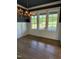 Dining room with natural light, wood floors, and a modern chandelier at 976 Knob Hill Dr., Hillsborough, NC 27278