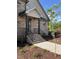 Welcoming front entrance with brick steps, dark wood pillars, and black iron railings at 976 Knob Hill Dr., Hillsborough, NC 27278