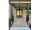 Inviting front porch with brickwork, a hanging lantern, and wood columns at 976 Knob Hill Dr., Hillsborough, NC 27278