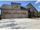Three-car garage with carriage doors and a spacious concrete driveway at 976 Knob Hill Dr., Hillsborough, NC 27278