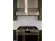 Stainless steel range and range hood over a stove with green cabinets and patterned backsplash at 976 Knob Hill Dr., Hillsborough, NC 27278