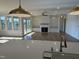 Spacious open-concept living area with fireplace, hardwood floors, and plentiful natural light from the large windows at 976 Knob Hill Dr., Hillsborough, NC 27278