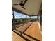 Covered porch with ceiling fans showcasing outdoor views of trees, blue sky, and clouds at 976 Knob Hill Dr., Hillsborough, NC 27278