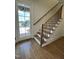 View of the home's staircase, entry door, and view of the outside through the glass pane at 976 Knob Hill Dr., Hillsborough, NC 27278