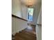 Staircase with wood steps and white walls lit by window and chandelier at 976 Knob Hill Dr., Hillsborough, NC 27278