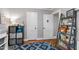Well-organized bedroom with hardwood floors, gray walls, and a blue patterned rug at 1003 E Club Blvd, Durham, NC 27704