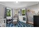 Charming Bedroom with a cozy chair, patterned rug, dresser with changing table, and bright, airy feel at 1003 E Club Blvd, Durham, NC 27704