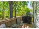 Outdoor deck with mature tree views, seating, and grill at 1003 E Club Blvd, Durham, NC 27704