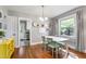 Dining room with a white table, modern furnishings, hardwood floors, and bright natural light at 1003 E Club Blvd, Durham, NC 27704